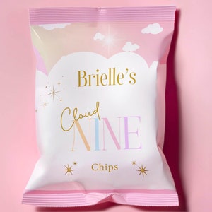 May include: A white bag of chips with a pink and white design. The bag has the text "Brielle's Cloud NINE Chips" on it.