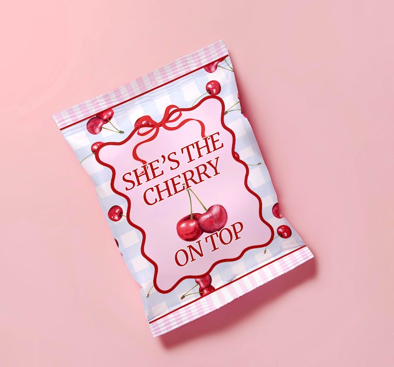 May include: A pink and blue checkered snack bag with a white label that says "She's the Cherry on Top". The label has a red bow and a cherry illustration.