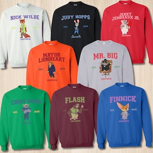 May include: A collection of crewneck sweatshirts in various colors, each featuring a character from the animated film "Zootopia." The sweatshirts display character names like "Nick Wilde," "Judy Hopps," and "Mr. Big," along with the year "2016" and the film's title.