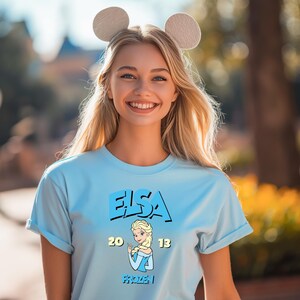 a woman wearing a blue tshirt with ears on her head