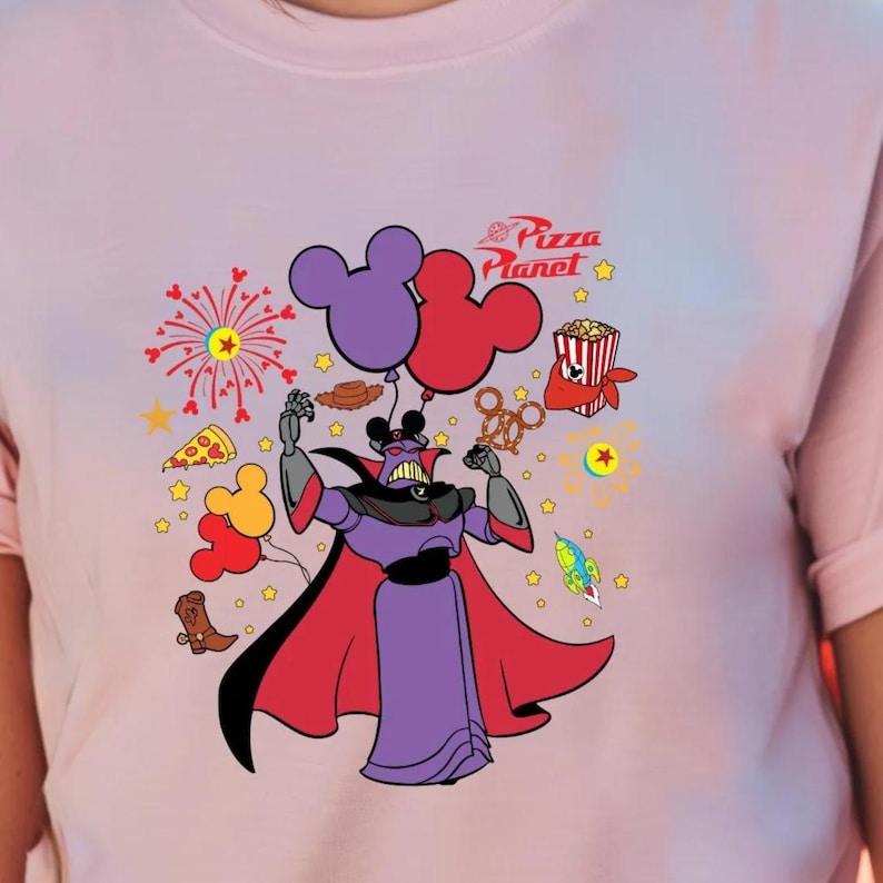 a woman wearing a pink shirt with a mickey mouse on it