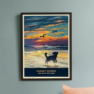 May include: A framed print titled "Sunset Shores and Salty Wet Paws" shows a dog running on a beach at sunset. The sky is a mix of orange, blue, and yellow. A sleeping dog rests below the print on a grey surface.