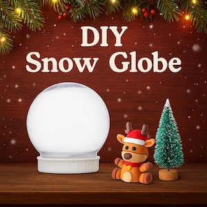 May include: A clear DIY snow globe kit with a white base, a reindeer figurine wearing a Santa hat, and a small green Christmas tree. The text "DIY Snow Globe" is displayed above the objects on a wooden surface.
