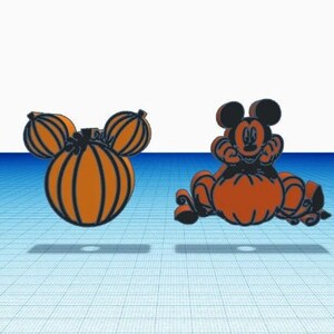 May include: Two decorative ornaments featuring orange and black designs. One is a pumpkin shaped like a mouse head with rounded ears. The other depicts a black mouse character sitting on top of a large orange pumpkin with carved details.