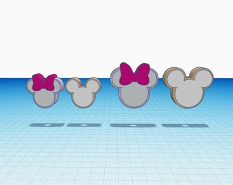 May include: Four three-dimensional mouse-shaped icons arranged in a row. Two icons feature a bright magenta bow on top, while the other two are plain. Each icon has a light gray face and a tan-colored side profile, casting a shadow on the surface.