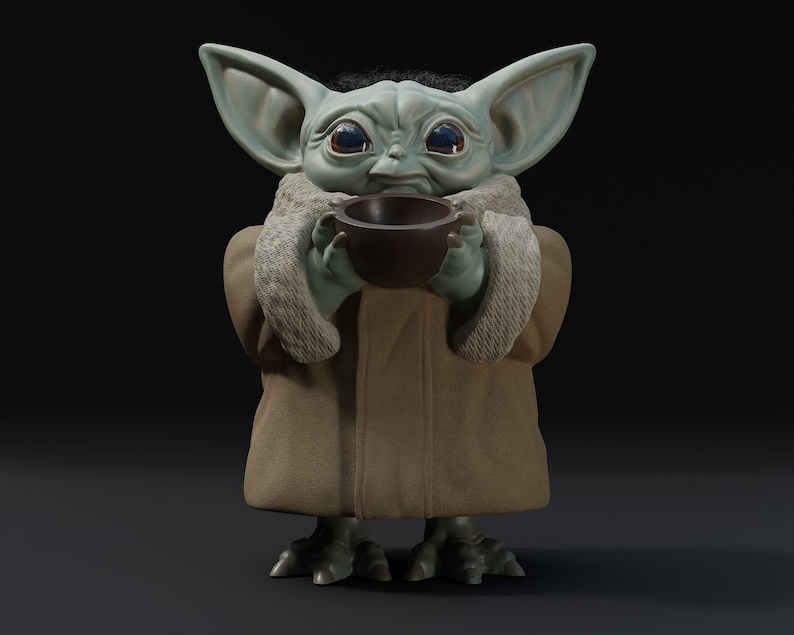 May include: A detailed figurine of a character from a popular science fiction franchise. The figure has large ears, big eyes, and is holding a small brown bowl. It is wearing a tan coat with a furry collar. The background is dark.