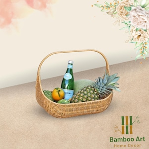 May include: A woven wicker basket with a handle, filled with a pineapple, oranges, and a bottle of sparkling water. The basket is on a light brown surface with a floral design in the background.