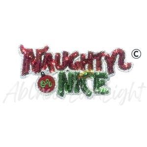 May include: A sequined Christmas ornament with the words "NAUGHTY" in red and "NICE" in green. The letters are outlined in silver and the word "NICE" has a small red and green ornament graphic.