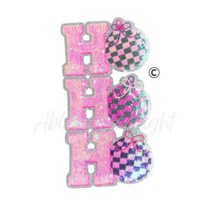 May include: A sequined patch featuring the letters "HOH" in pink, with a silver glitter border. Each "H" is stacked vertically. Three ornaments with a checkered pattern in pink, black, and white are to the right of the letters. Each ornament has a bow.