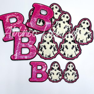May include: Pink and black felt patches with the letters "BOO" and ghost designs.
