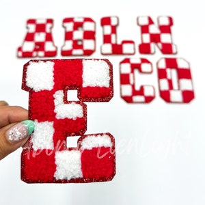 May include: Red and white checkered felt letters spelling out the word "ABLECO". The letters are in a vintage style and have a fuzzy texture.