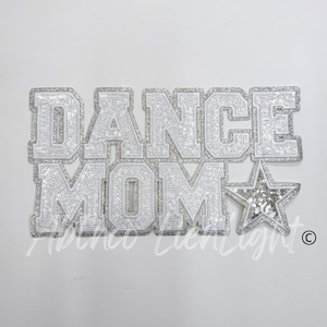 May include: Silver glitter iron-on patch with the words "Dance Mom" and a silver glitter star.