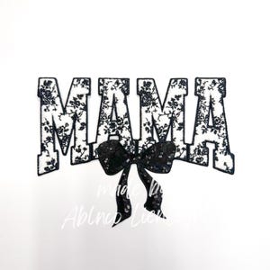 May include: Black and white floral fabric letters spelling "MAMA" with a black sequined bow in the center.