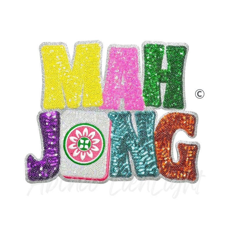 May include: A colorful sequined design spelling out "MAH JONG" in yellow, pink, green, purple, teal, and orange. The "J" is purple, and the "ONG" is teal and orange. The "MAH" is yellow, pink, and green. The design includes a Mahjong tile.