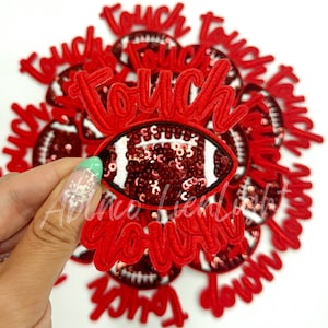 May include: Red and white iron-on patch with the words "touch down" and a sequined football design.