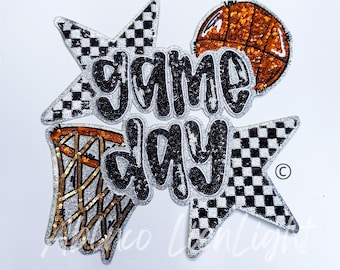 May include: A black and white chequered star with the words "game day" in black and white sequins. A basketball and a basketball hoop are also featured in the design.