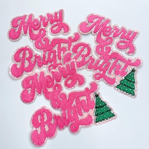 May include: Pink felt patches with the words "Merry & Bright" and a green Christmas tree design.