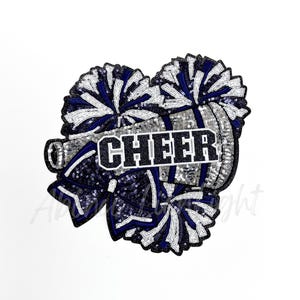 May include: A silver and blue sequined iron-on patch with two pom-poms and the word "CHEER" in black.