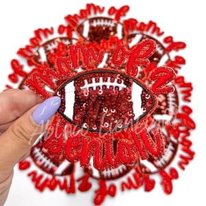 May include: Red and white iron-on patch with the text "Mom of a Senior" and a red sequined football.