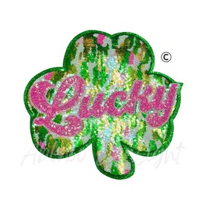 May include: A sequined shamrock patch with the word "Lucky" in pink glitter. The shamrock has a green glitter border and a colorful sequin filling with green, gold, and pink hues. The patch is likely for St. Patrick's Day.