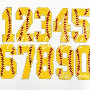 May include: Ten yellow and red softball-themed iron-on patches with numbers 1 through 10. The patches are made of sequins and have a white outline.