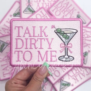 May include: Pink embroidered patch with a martini glass and the text "Talk Dirty To Me".