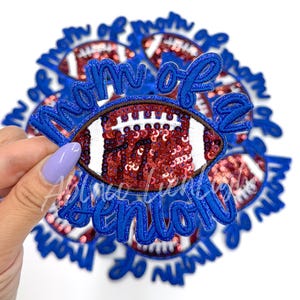 May include: Blue and red iron-on patch with the text "Mom of a Senior" and a sequined football design.