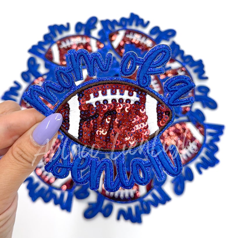 May include: Blue and red iron-on patch with the text "Mom of a Senior" and a sequined football design.