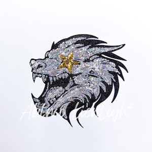 May include: A black and silver sequined iron-on patch of a snarling wolf's head with a gold star over its eye.