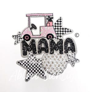 May include: A pink golf cart with a black and white checkered star and the word "MAMA" in black sequins. The design is surrounded by silver sequins.