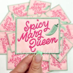 May include: A pink and green embroidered patch with the text "Spicy Marg Queen" and a green chili pepper.