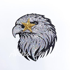 May include: A black and silver sequined eagle head with a gold star over its eye. The eagle is a popular symbol of freedom and strength.