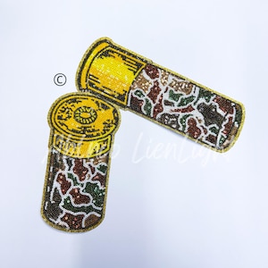 May include: Two gold and green camouflage patterned shotgun shell patches. The patches are made of sequins and are about 4 inches long.