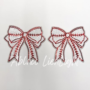 May include: Two white and red sequined bows with a baseball stitch design.