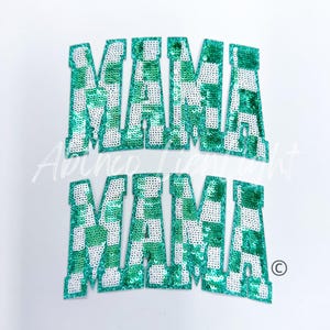 May include: Two green and white checkered sequin patches that spell out "MAMA" in large, bold letters.