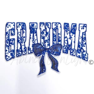 May include: Blue and white embroidered patch with the word "GRANDMA" and a blue sequined bow.