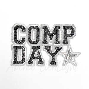 May include: Black and silver iron-on patch with the text "COMP DAY" and a silver star.