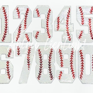 May include: Ten white iron-on patches with red stitching in the shape of baseball numbers 1 through 10.
