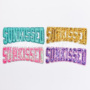 May include: Four iron-on patches with the word "SUNKISSED" in different colors: teal, gold, pink, and purple.
