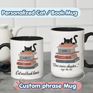 May include: Two white ceramic mugs with black interiors and handles. Each features a black cat peeking over a stack of colorful books. The left mug says "Cat and book lover" and the right mug says "One more chapter... says the cat."