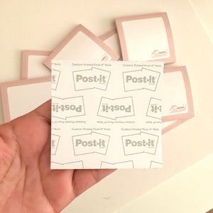 May include: A stack of pink Post-it notes with the text "Custom Printed Post-it Note" and the Post-it logo. The notes are blank and ready to be written on.