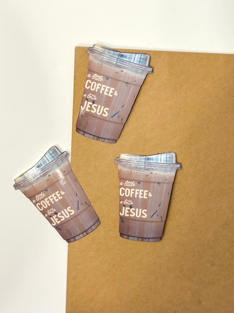 May include: Three brown paper coffee cups with lids. Each cup has the text "a little COFFEE & a lotta JESUS" printed on the side.