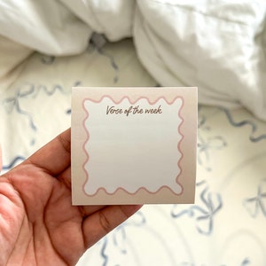 May include: A beige and pink card with a scalloped border. The card says "Verse of the week" in brown text.