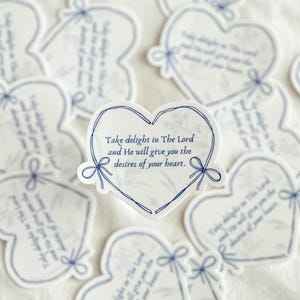 May include: A set of heart-shaped stickers with a blue and white marble pattern. The stickers feature the text "Take delight in The Lord and He will give you the desires of your heart."