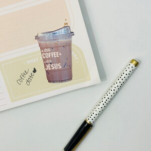 May include: A yellow planner with a sticker of a coffee cup that says "a little coffee & a lotta JESUS". The planner has a section that says "WHAT I LOVE" and a section that says "TODAY".