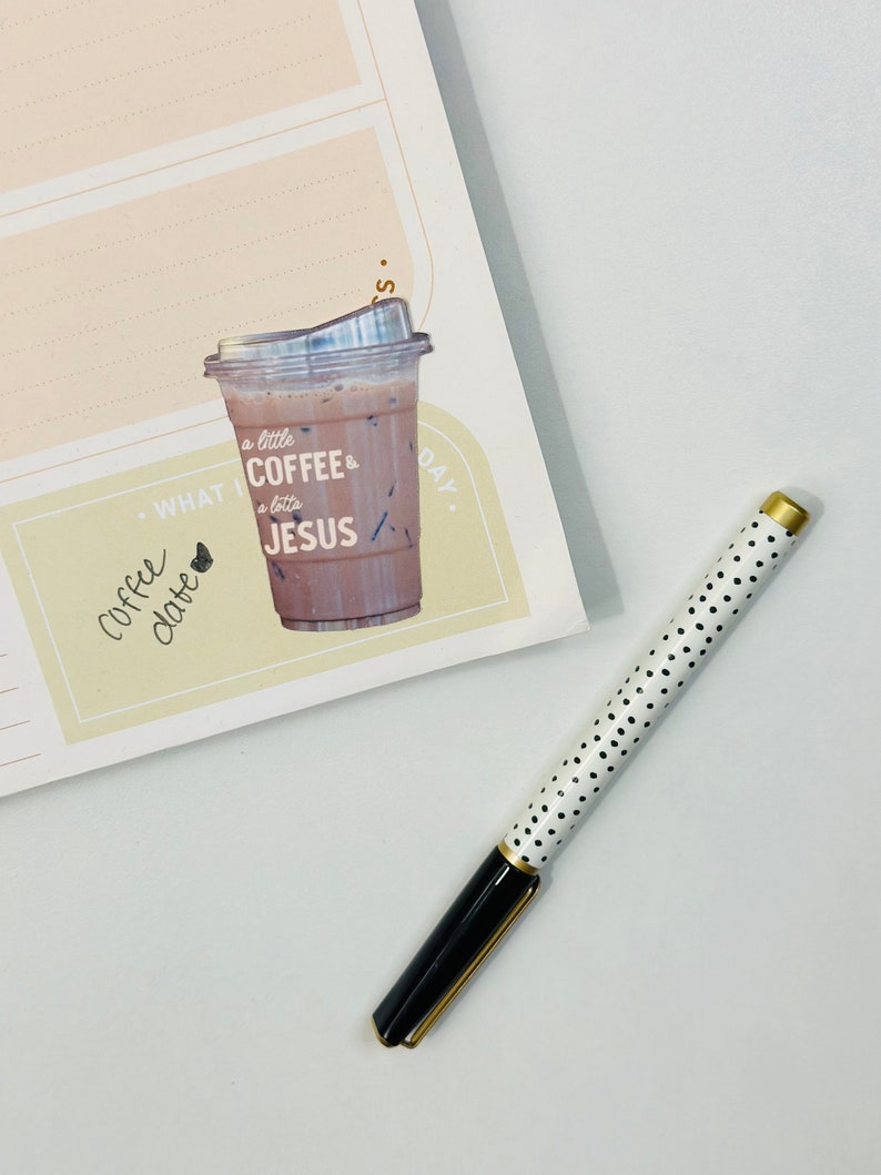 May include: A yellow planner with a sticker of a coffee cup that says "a little coffee & a lotta JESUS". The planner has a section that says "WHAT I LOVE" and a section that says "TODAY".