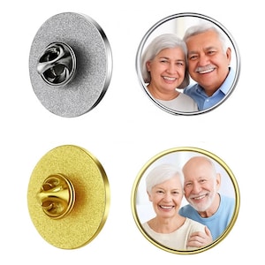 May include: Two round lapel pins, one silver and one gold, each with a pin back. The silver pin has a textured surface. The gold pin has a textured surface. Each pin has a photo of a smiling couple.