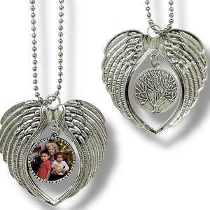 May include: Two silver-colored angel wing ornaments. One features a family photo within a heart-shaped frame, the other a tree of life design. Both hang from a beaded chain, suitable for a rearview mirror or display.