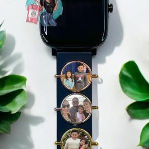 May include: A black smartwatch with a blue band and three round photo charms. The charms are gold, silver, and rose gold and each features a different family photo.