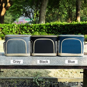 May include: Three insulated lunch bags in gray, black, and blue. The bags have a zipper closure and a carrying handle. The bags are labeled "Gray", "Black", and "Blue".